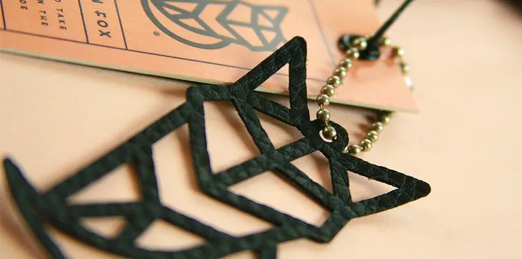 Laser-cut fox logo tag on a chain