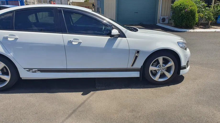 White Holden Commodore with side stripe graphics