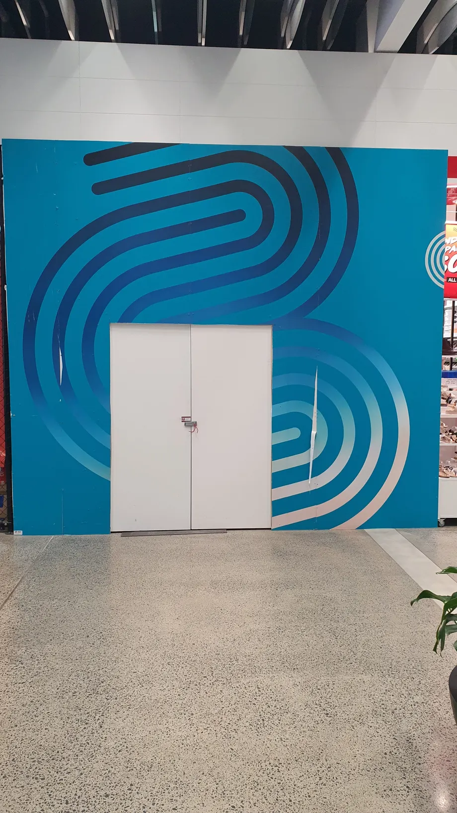 Busselton Central hoarding graphic around a service door