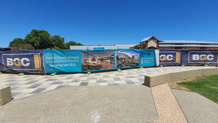 Busselton Central construction fence banners along a paved plaza