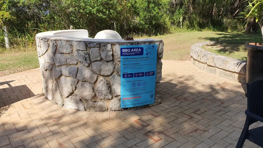 Club Wyndham BBQ area sign on a curved stone wall