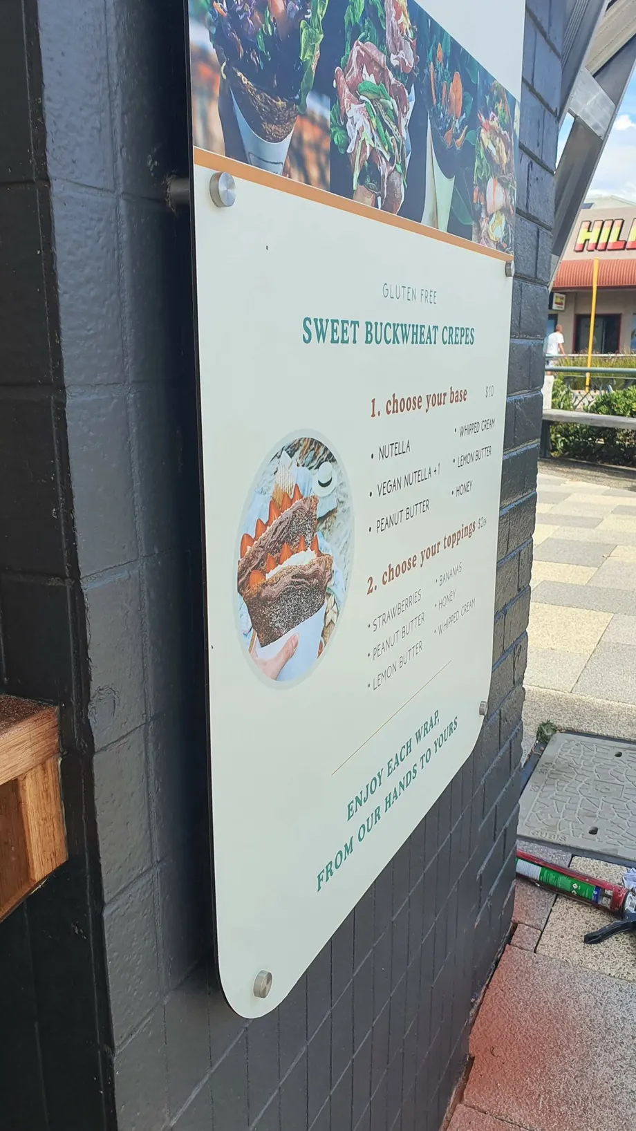 Menu board mounted beside a café entrance