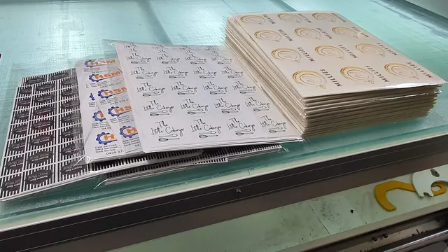 Sheets of printed stickers on the workshop bench