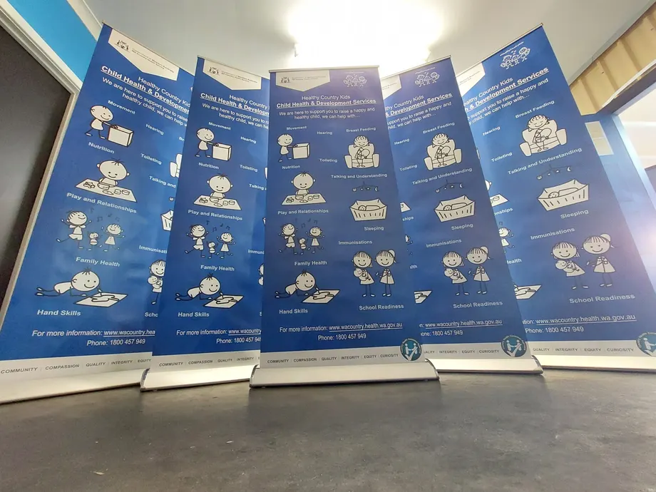 Pull-up banners for child health and development services in a workshop