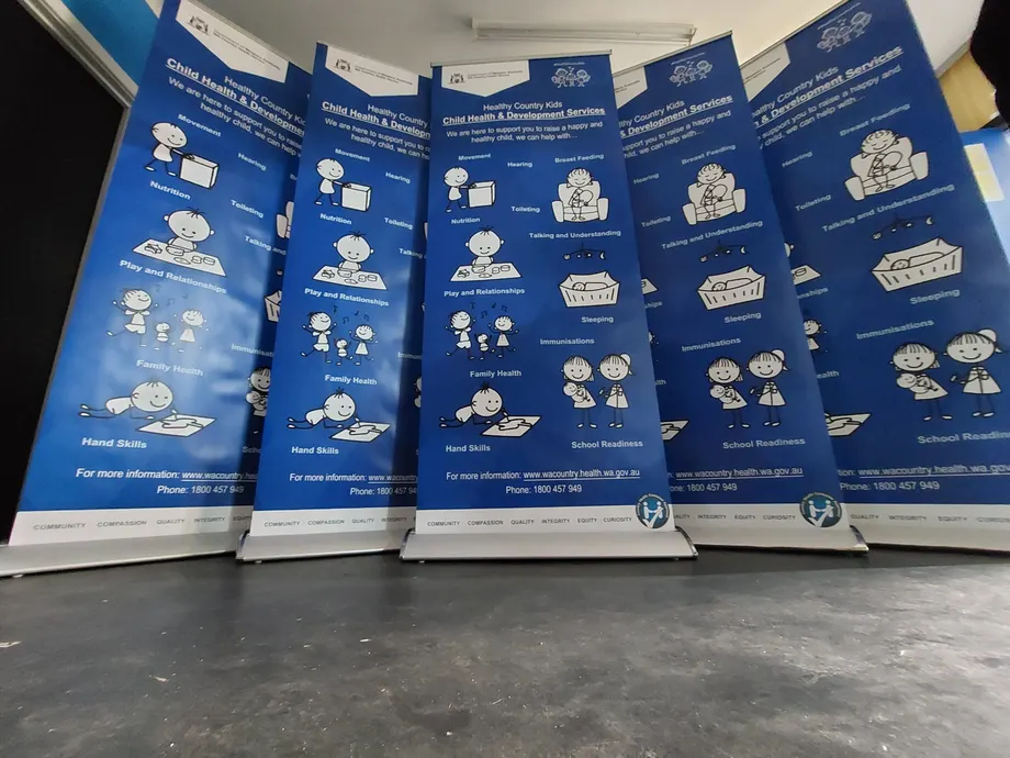 Row of pull-up banners for child health and development services
