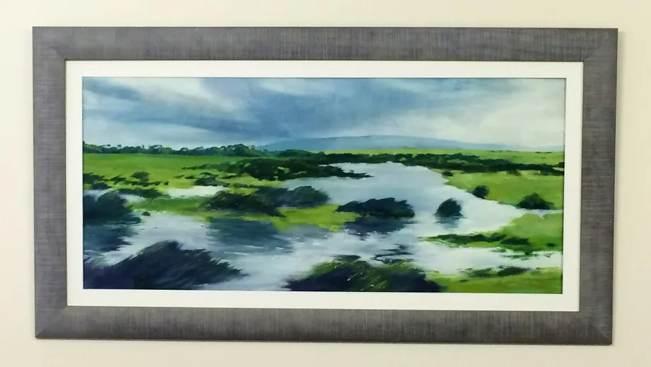 Framed landscape print in a grey frame