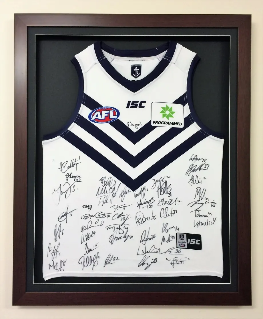 Signed Fremantle AFL jersey in a shadow box frame