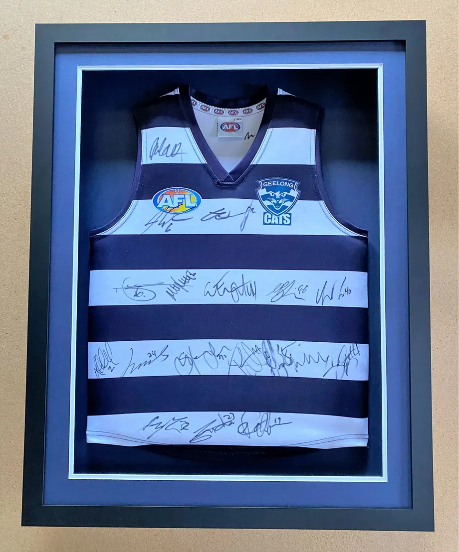 Signed Geelong AFL jersey in a shadow box frame