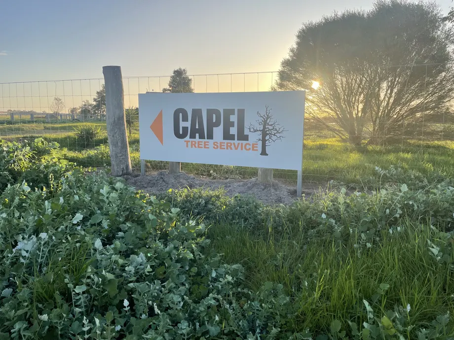 Capel Tree Service sign on posts beside a paddock