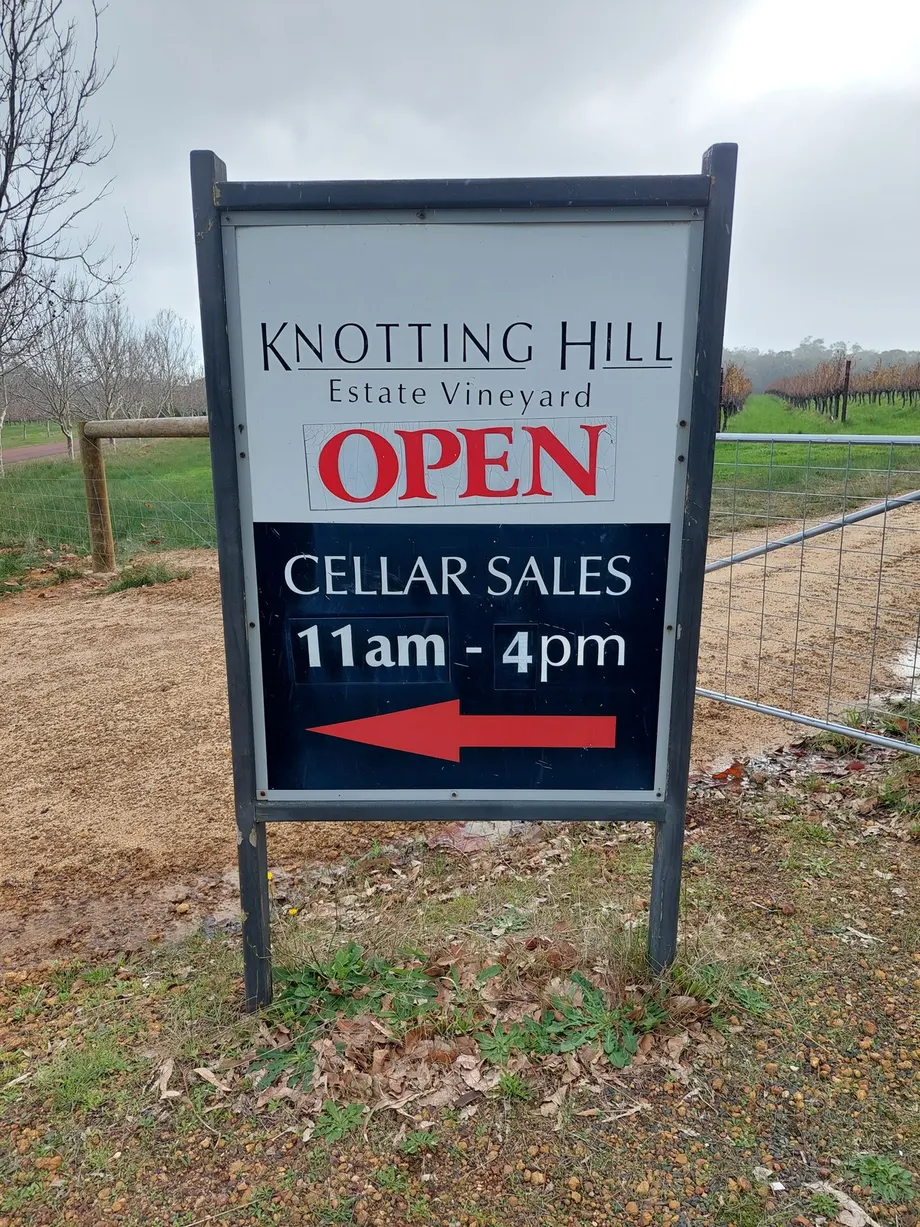 Knotting Hill Estate Vineyard cellar door sign with a red arrow