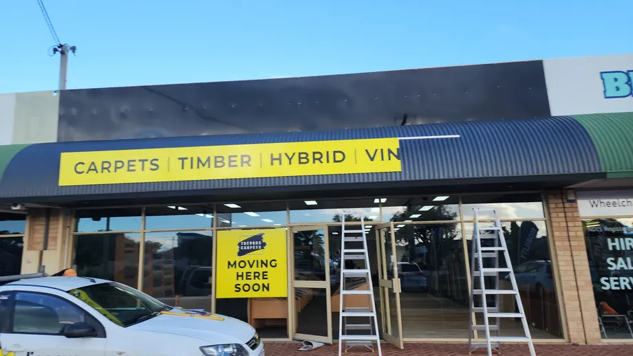 Trevors Carpets vertical sign panel on the building corner