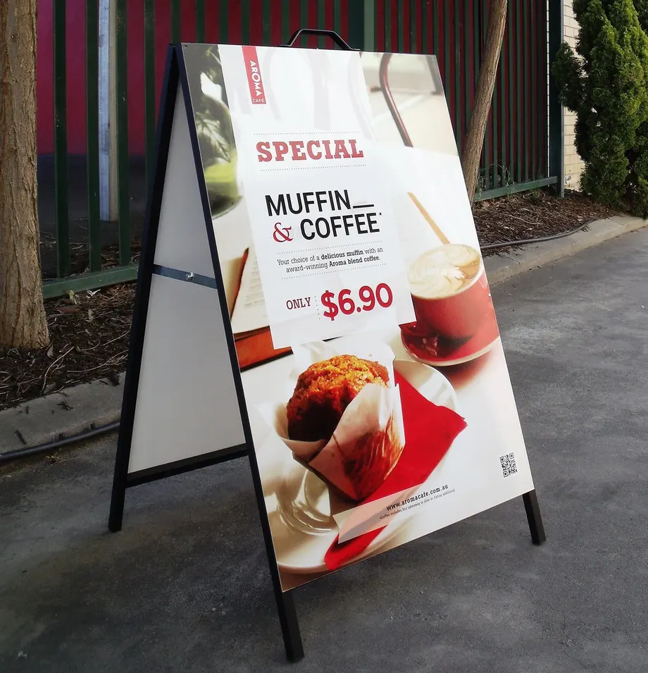 Metal-faced A-frame sign advertising a muffin and coffee special