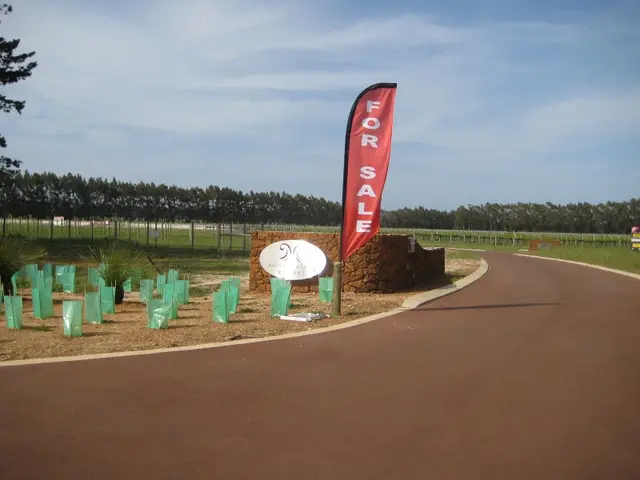 Red feather flag beside a new land estate
